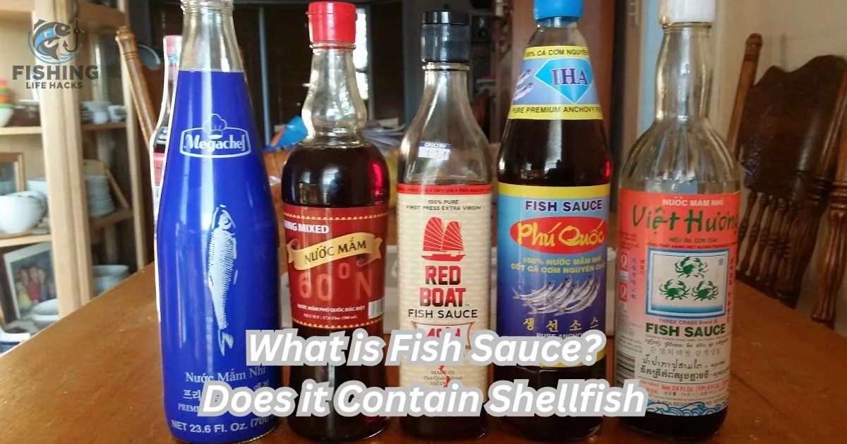 Close-up of a glass bottle of fish sauce, showing the dark amber color and depth of flavor that defines what is fish sauce. This savory condiment sits on a wooden table, with fresh herbs, lime wedges.